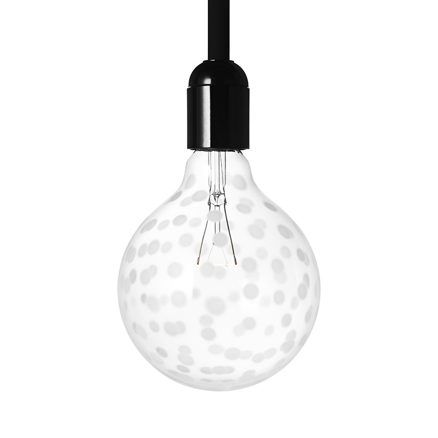 The Orrefors: Light Shadow Confetti 25W Light Bulb features a hanging design with a black socket and a clear glass surface adorned with sand-blasted motifs resembling translucent dot patterns.