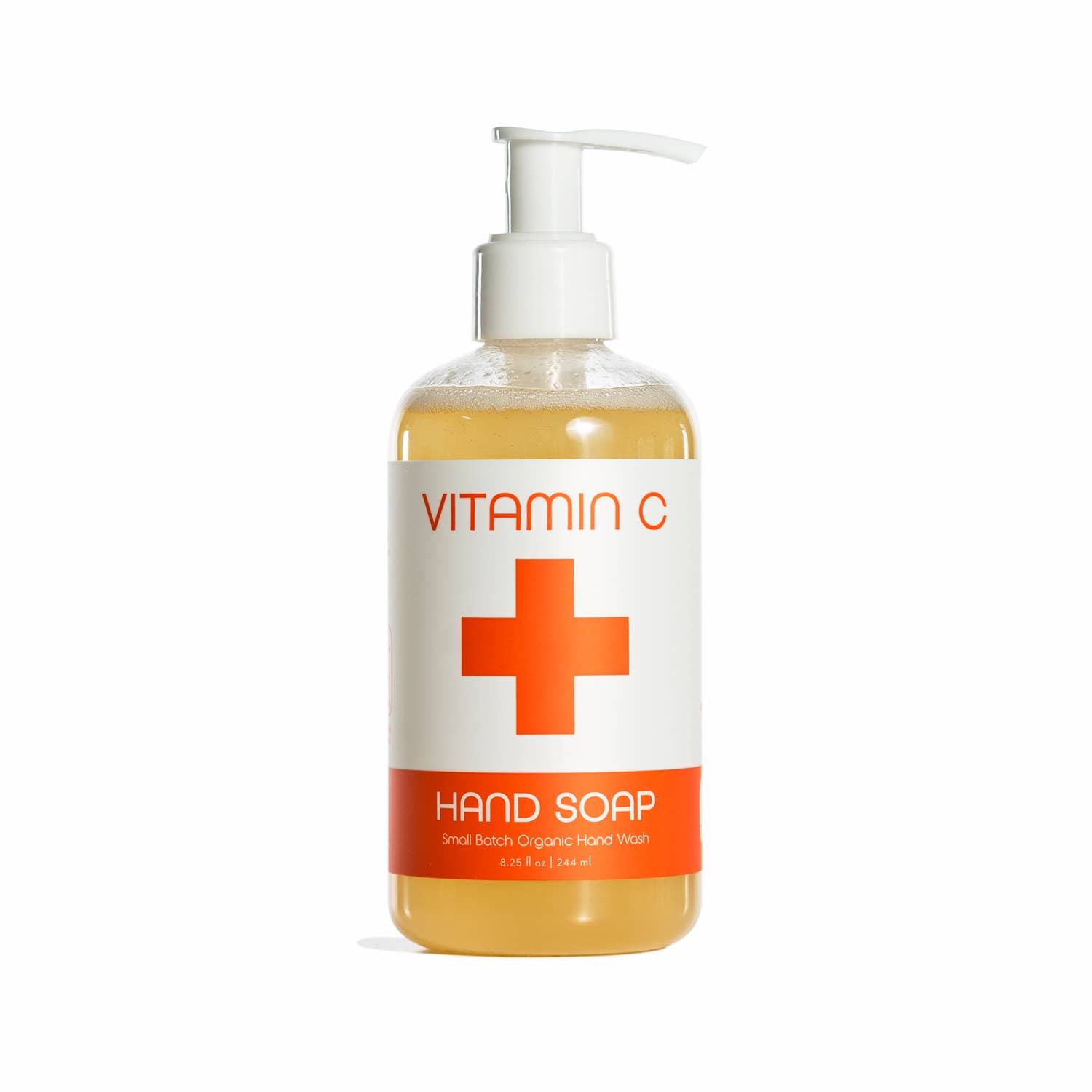 Nordic+Wellness™ Vitamin C Liquid Hand Soap with a pump, enriched with Arctic Cloudberry Oil, features a large red cross and Small Batch Organic Hand Wash label on a white and orange design.