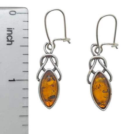 Earrings: Celtic Dangle Cognac Amber Sterling Silver Earrings shown beside a ruler to highlight their 1.5-inch length and marquise-shaped genuine Baltic amber stones.