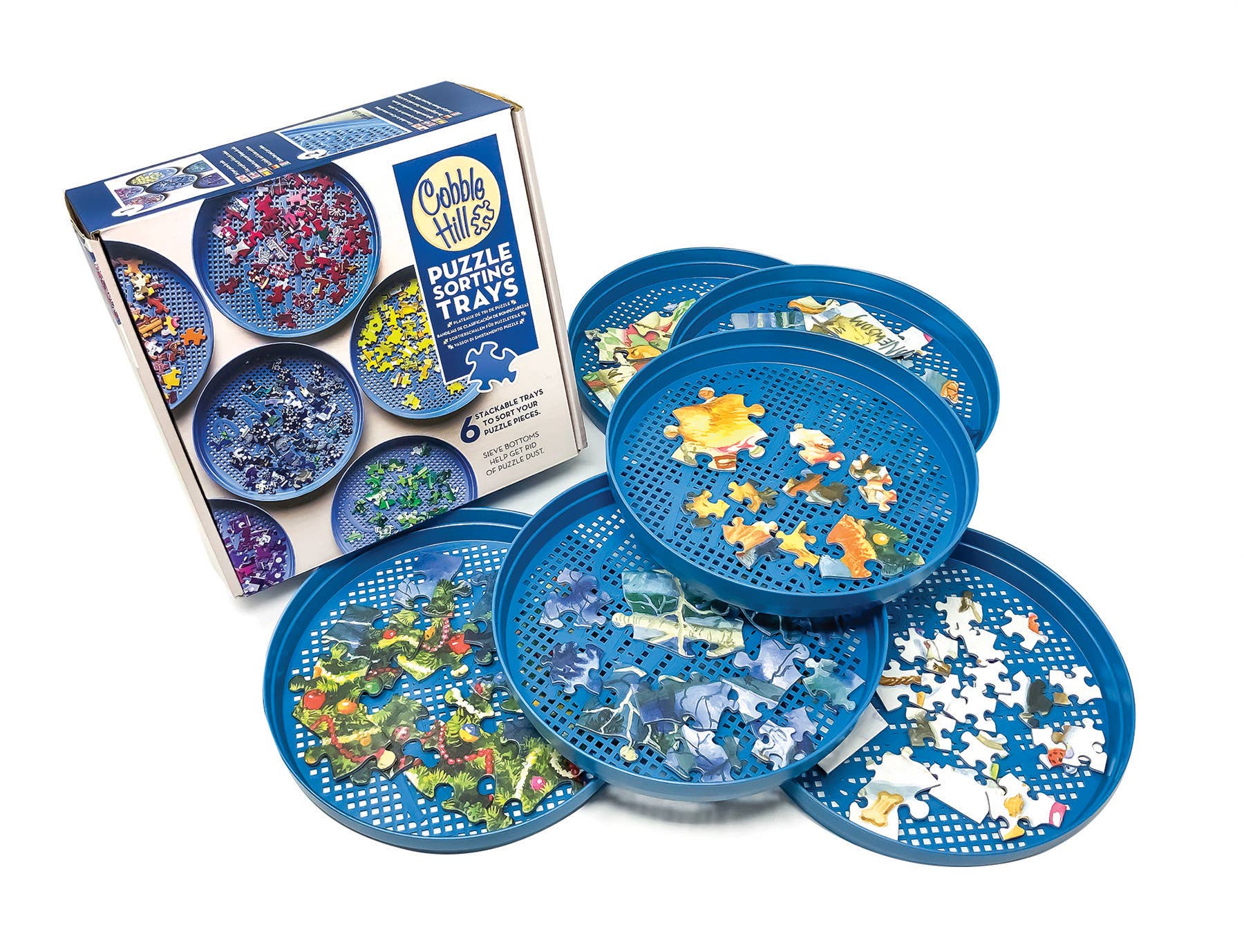 The blue Puzzle Sorting Trays, which are stackable, hold various jigsaw puzzle pieces alongside the product box.