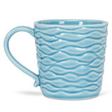 The Wavy Aqua Mug with Loon in Recess is a handcrafted ceramic mug (14oz, 4"H) featuring a light blue wavy texture and curved handle—a nature-inspired gift shown on a white background.