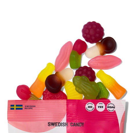 A pink and white Sockerbit Candy: Sweet Gummy Mix Swedish Candy Bag 2.8oz spills out colorful, non-GMO Swedish gummies in fun shapes like bottles, lips, fish, and fruit.