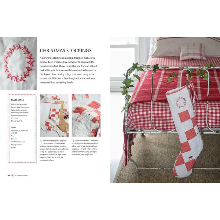 A Christmas stocking in red and white patchwork, inspired by the book "Scandinavian Christmas Crafts," hangs on a bed frame near a red plaid quilt; instructions and materials list are visible on the left.