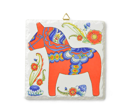 The Red Swedish Dala Horse Ceramic Deluxe Plaque (6x6) features a stylized horse with blue/yellow patterns, vibrant florals, beveled edges, cork backing, and a metal hanger—celebrating Swedish heritage and craftsmanship.