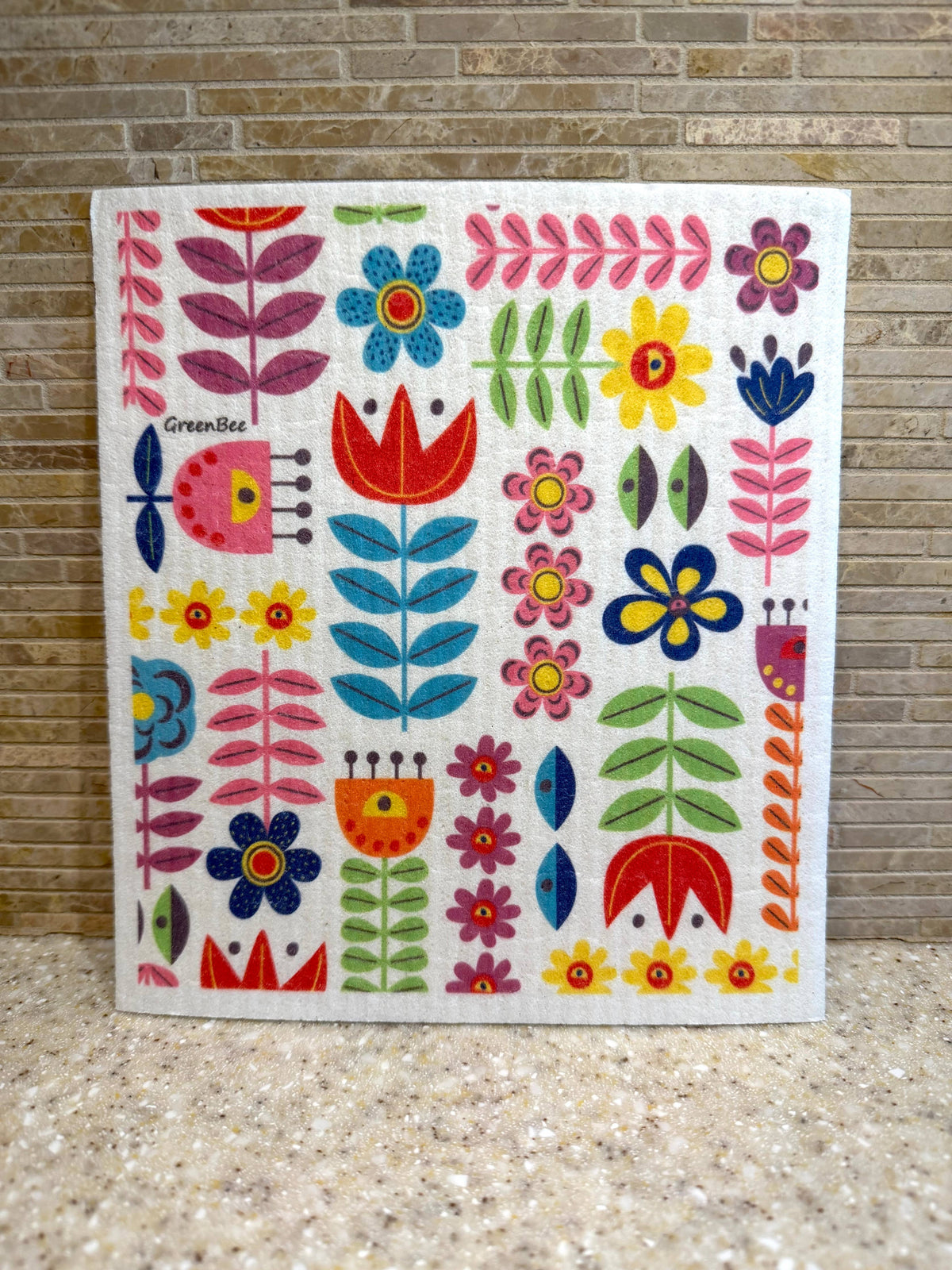 Square Swedish dishcloth featuring a colorful folk-art pattern of stylized flowers and leaves.