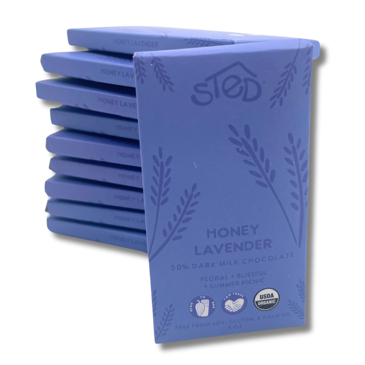 A stack of chocolate bars labeled Honey Lavender, 50% organic milk chocolate, with USDA organic seal and notes indicating soy free, gluten free, and palm oil free.