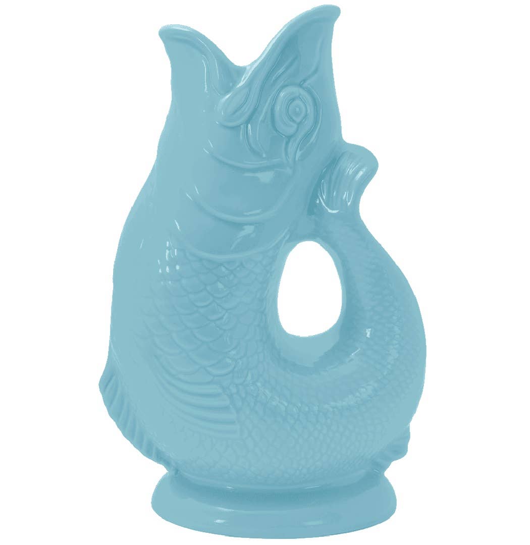 This whimsical jug, known as the Gluggle Jug: Pale Blue Gluggle Jug Extra Large, features a light blue ceramic design shaped like a fish with an open mouth and a curved handle.