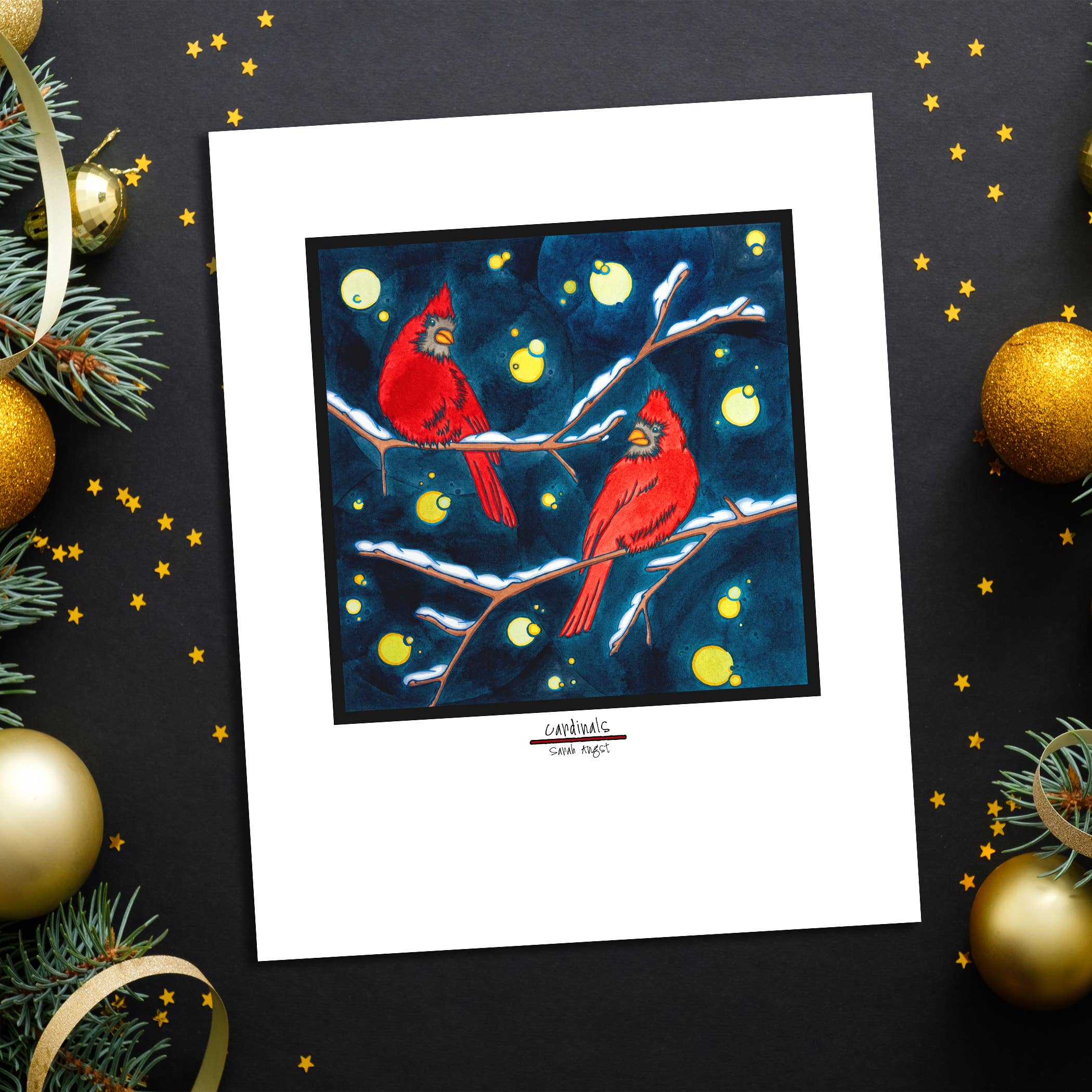 The "Artwork: Winter Cardinals: 8\"x10\" Giclee Print" beautifully showcases two winter cardinals perched on snowy branches set against a dark blue background, embellished with decorative gold balls, pine branches, and star confetti. This piece is perfect as Christmas decor to add festive warmth and charm to any space.