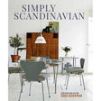 Cover of Simply Scandinavian by Sara Norman features a minimalist room with a dining table, chairs, plants, and a wooden cabinet made from natural materials, epitomizing Scandinavian interior design.