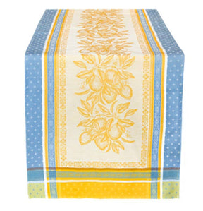 Cotton table runner with yellow and blue stripes, a central pattern of yellow flowers and lemons on a cream background.