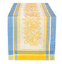 Cotton table runner with yellow and blue stripes, a central pattern of yellow flowers and lemons on a cream background.