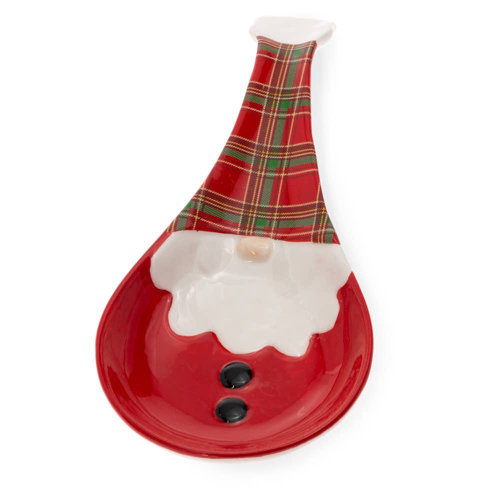 The Wallace Plaid Santa Gnome Ceramic Christmas Spoon Rest is a ceramic spoon rest featuring a Santa Claus face, red and green plaid hat, and two black buttons.