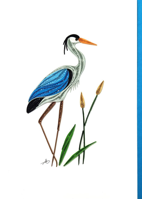 The Card: Blue Heron and Cattails Quilling Card (5x7 inches, blank inside, aqua envelope) features handcrafted quilled art of a blue heron with cattails—an ideal greeting card for nature lovers.