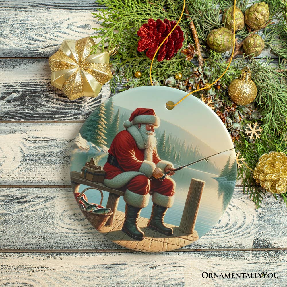 The "Peaceful Fishing Session with Santa Claus Christmas Ornament" is an ideal Christmas gift for anglers, featuring Santa in a red suit fishing on a dock by a lake, surrounded by scattered festive decorations.