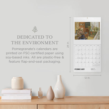 The Calendar: Carl Larsson 2026, sized 24 x 12 inches, hangs above a shelf with decor; its text highlights eco-friendly materials, packaging, and Swedish art in this beautiful 2026 wall calendar.