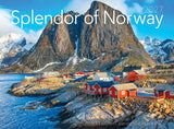 Wall calendar cover showing red cabins on a rocky shoreline, snowy mountain peaks in the background, and a clear blue sky above.