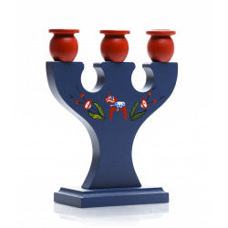 A hand crafted Swedish candle holder in blue wood features three red holders, decorated with a red airplane and green leaves, capturing the traditional charm of a Dala Horse.