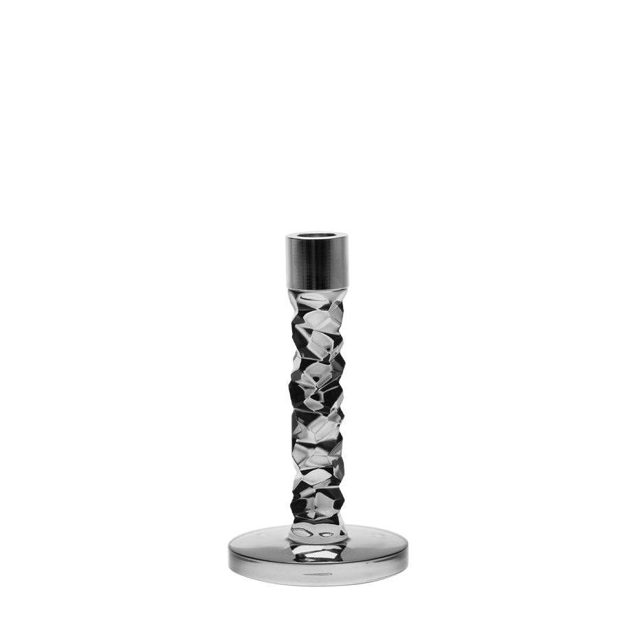 The Orrefors Carat Graphite Candlestick Small is showcased, highlighting its textured faceted crystal glass stem and smooth silver circular base on a plain white background.