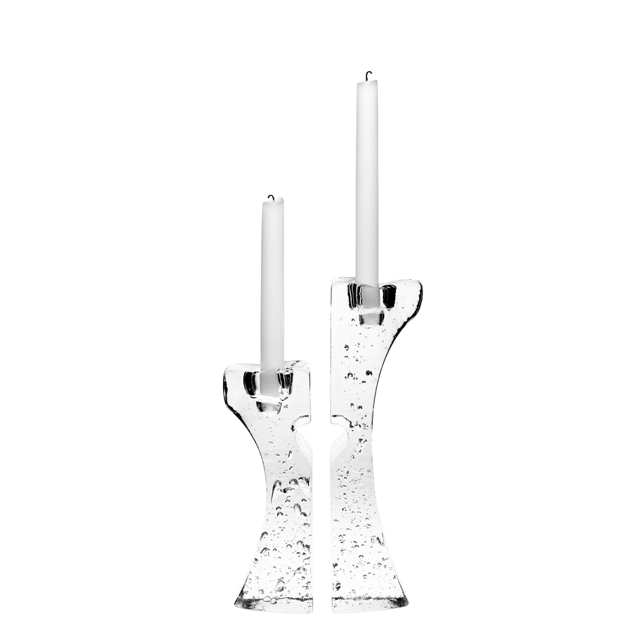 The KostaBoda: Connect Candlestick (2-Pack) showcases Kjell Engmans artistry with two clear glass holders, each featuring textured surfaces and holding a white tapered candle.