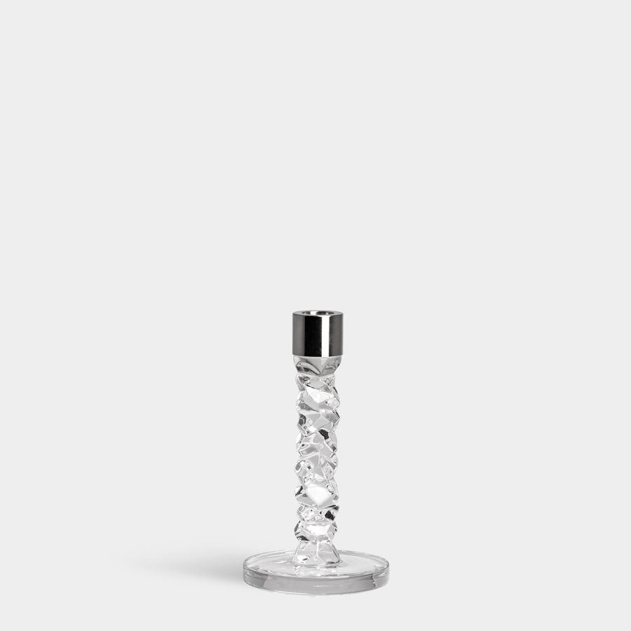 The Orrefors: Carat Candlestick Silver Small, featuring a clear crystal textured stem and round base, is displayed against a plain, light gray background.