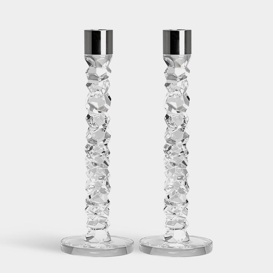 Two Orrefors Carat Candlestick Silver Large (2-Pack) crystal glass candlesticks with faceted stems and metal tops are on a flat surface against a plain background.