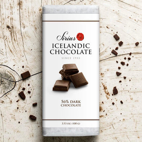 Nói Síríus chocolate bar wrapper with pieces of 56% dark chocolate on a wooden surface; visible text includes “3.53 oz (100g)”.
