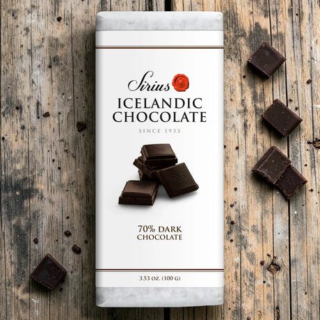 An Icelandic dark chocolate bar on a wooden surface, with several pieces of 70% dark chocolate arranged nearby.