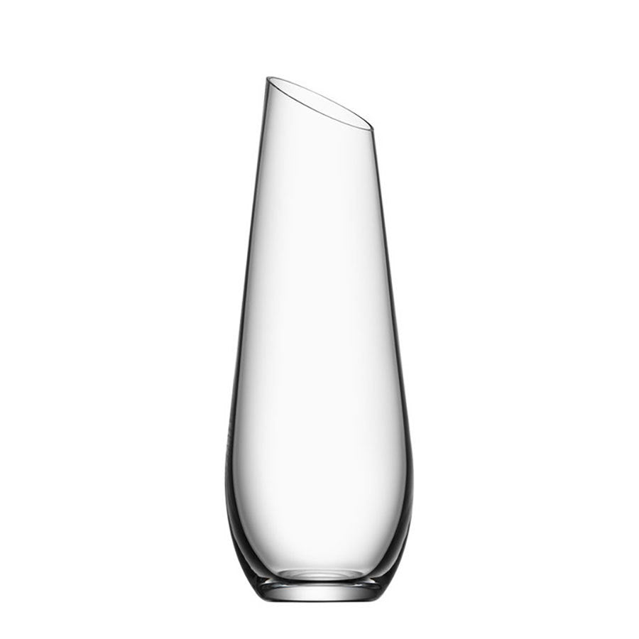 The Orrefors Enjoy Carafe 27oz, designed by Erika Lagerbielke, showcases a clear glass design with a slanted top and smooth surface.