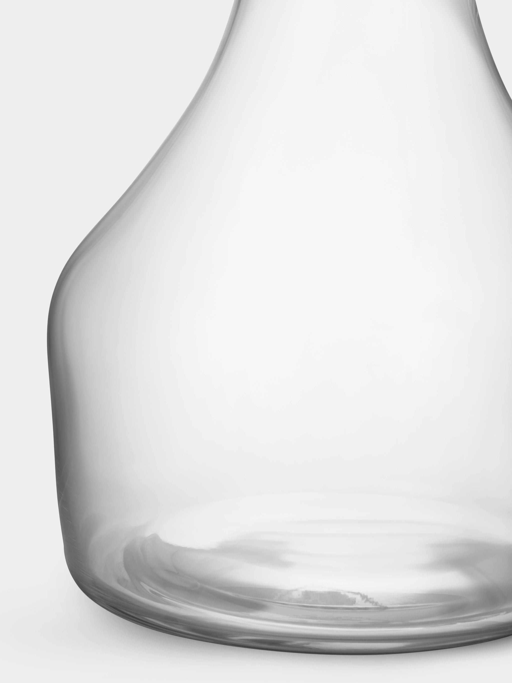 Close-up of an Orrefors: Share Carafe Large 41.5oz, featuring a wide base and narrow neck, set against a plain white backdrop, evoking an elegant crystal glass vase.