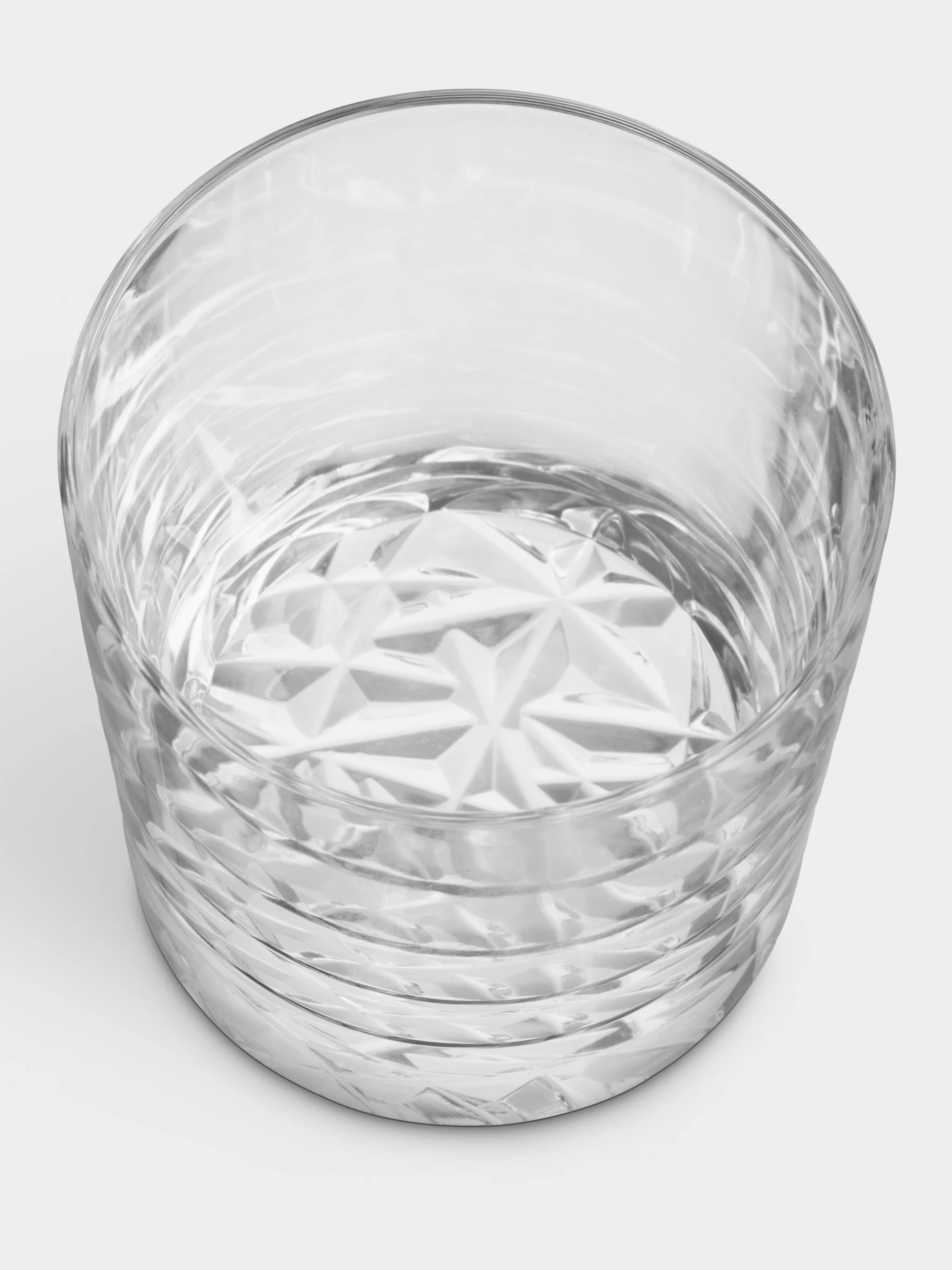 An Orrefors Carat Old Fashioned Glass from a 4-pack, textured and clear, filled with water and viewed from a slightly overhead angle.