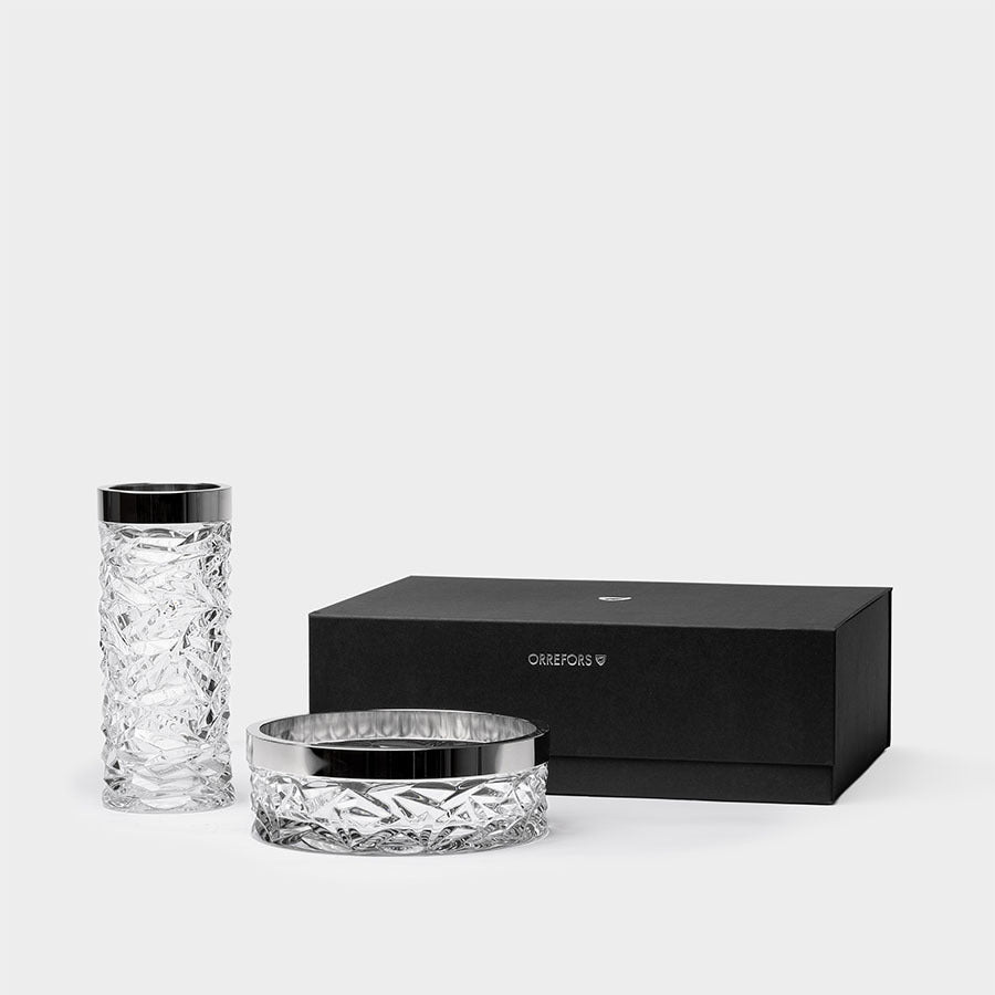 The Orrefors: Carat Bowl & Vase Bundle with engraved patterns is elegantly placed beside a black rectangular box.