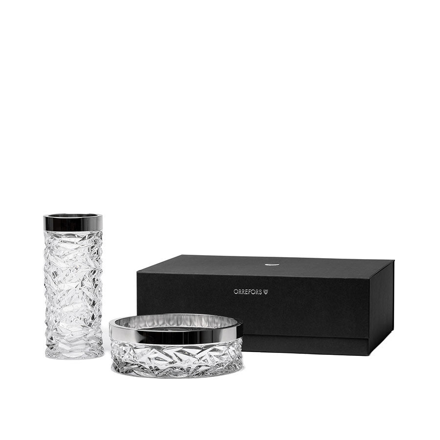 The Orrefors: Carat Bowl & Vase Bundle with silver accents is elegantly displayed next to a sleek black box.