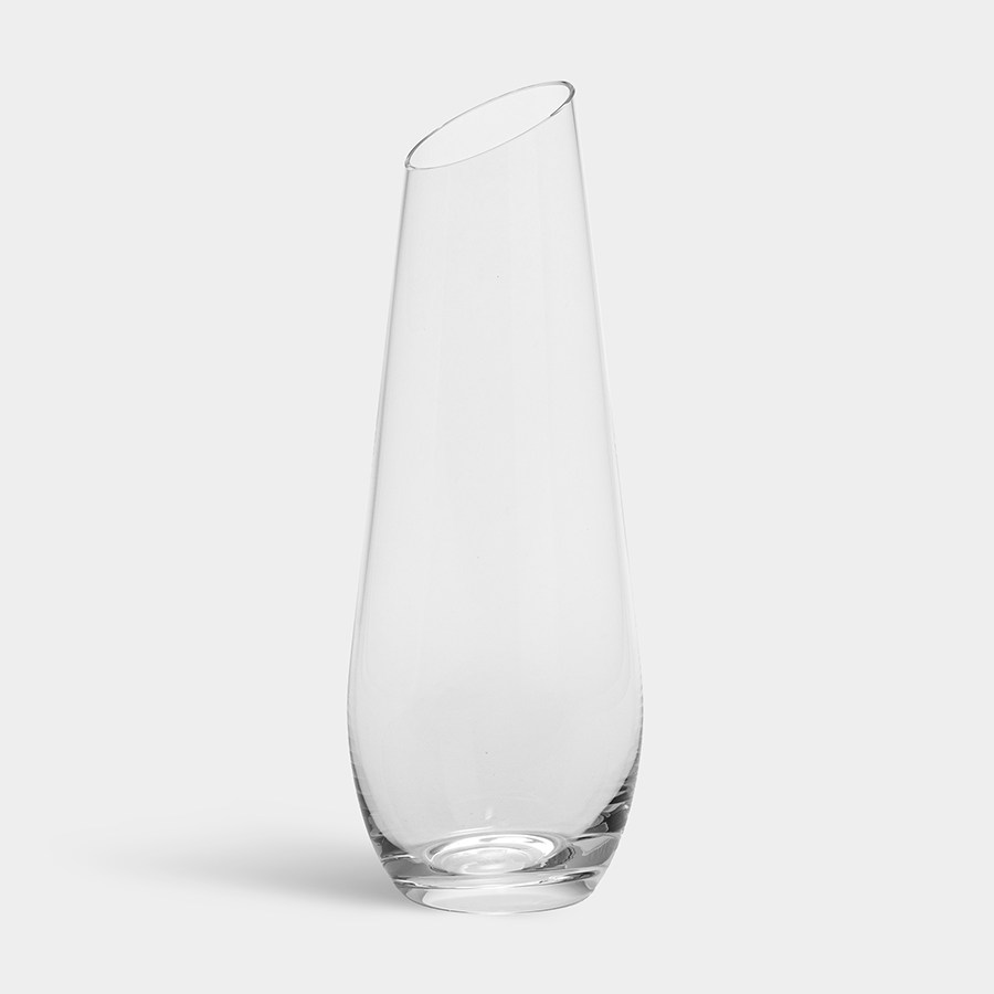 A clear Orrefors Enjoy Carafe 27oz with a slightly angled rim stands elegantly against a plain background, echoing Erika Lagerbielkes refined designs.