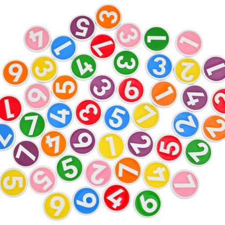 Bright plastic chips from Game: Chipzi - Fast Flippin' Fun! by Tenzi - Carma Games LLC feature bold white numbers from 1 to 7 on backgrounds of green, yellow, orange, red, purple, blue, and pink. These colorful pieces—ideal for a lively family game night—are scattered at random across a white surface.