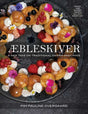 A wreath of Danish pancakes (Aebleskiver) with cream, berries, and flowers decorates the cover of Book: Aebleskiver by Pim Pauline Overgaard A New Take on Traditional Danish Pancakes.