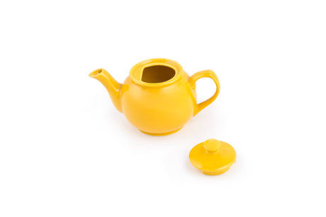 The Tea Pot: Yellow Earthenware Teapot 37-Ounce, shown with its lid removed and a stay-cool handle, is set against a white background.