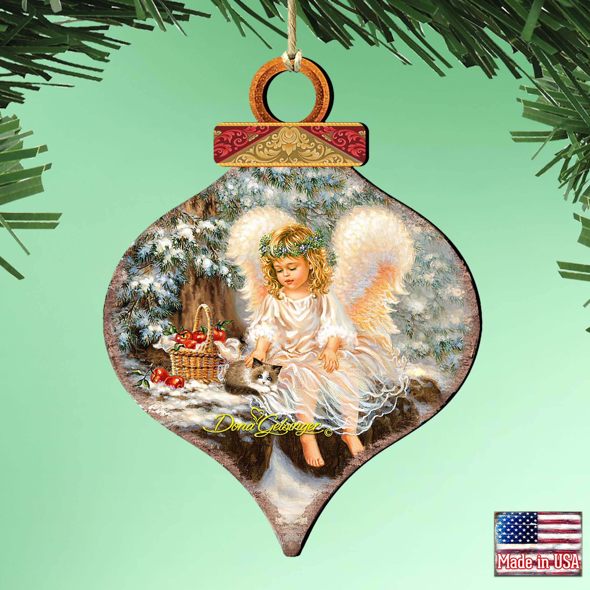 G.DeBrekht Artistic Studios presents the ANGEL CARDINAL Wood Ornament Gelsinger Holiday, an intricately handcrafted Christmas ornament depicting an angel in a snowy forest with a basket of apples. The Made in USA label affirms its quality and charm.