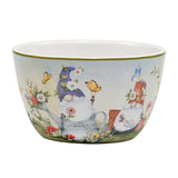 A ceramic bowl featuring garden gnomes with colorful hats, surrounded by flowers, butterflies, and a blue bird. Product: Garden Gnome Ice Cream Bowl, 5.25 x 3, with four image options.