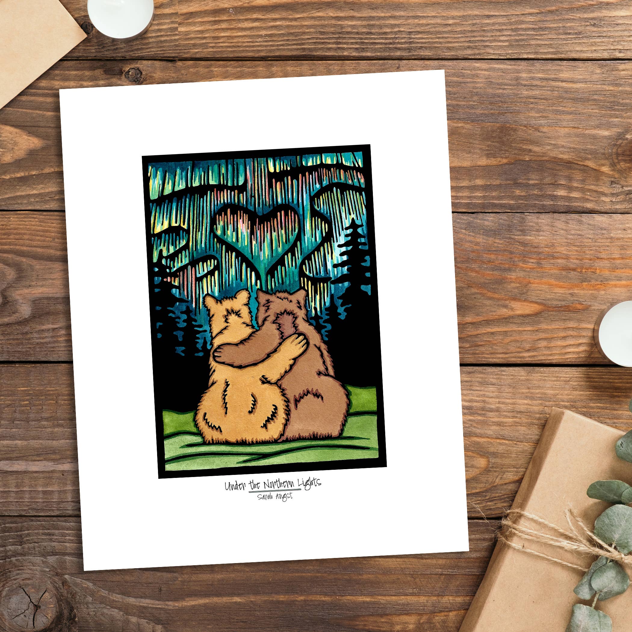 The Under the Northern Lights 8x10 giclee print by Sara Angst beautifully captures two bears sitting together, surrounded by trees and a heart shape in the swirling auroras. Perfect for art prints or a giclee piece.