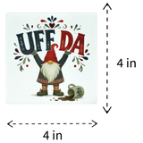 4-inch square Nordic gnome coaster featuring a gnome holding the words UFF DA overhead with a spilled mug on the ground.