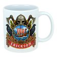 White mug featuring a Norse crest with axes, a Viking helmet, two black birds, a ship on water, and “ERICKSON” in bold red letters below the design.