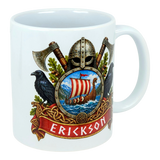 Ceramic mug featuring a Norse crest with a Viking helmet, crossed axes, two ravens, a sailing ship on water, and a red banner displaying the name Erickson.