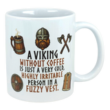 Ceramic mug with Nordic Viking art, featuring an axe and helmet illustration, and the text: “A Viking without coffee is just a cold, irritable person in a fuzzy vest.”.