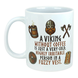 White ceramic mug featuring illustrations of a Viking helmet, axes, mug, shield, and vest, with the printed text: “A Viking without coffee is just a very cold...fuzzy vest.”.