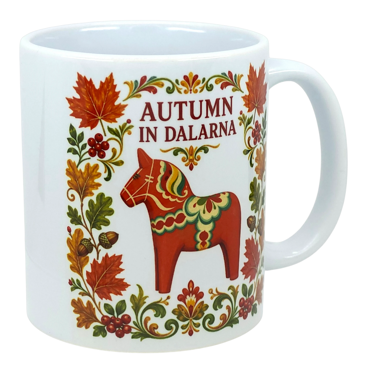 White mug featuring Scandinavian folk art with autumn leaves, acorns, a red Dala horse, floral patterns, and text reading “Autumn in Dalarna.”.