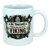 Start your day like a true legend with the Mug: Be Yourself Unless You Can Be A Viking Ceramic Mug (11 oz Capacity) from Nordic Wholesale. This white ceramic mug features striking Viking-themed artwork depicting two axes and a wooden shield, along with the empowering text: "Be Yourself. Unless you can be a VIKING." Ideal for fans of Norse mythology mugs and anyone who admires legendary warriors as part of their morning coffee ritual.