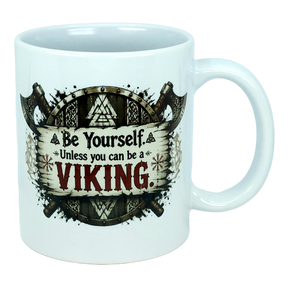 Start your day like a true legend with the Mug: Be Yourself Unless You Can Be A Viking Ceramic Mug (11 oz Capacity) from Nordic Wholesale. This white ceramic mug features striking Viking-themed artwork depicting two axes and a wooden shield, along with the empowering text: "Be Yourself. Unless you can be a VIKING." Ideal for fans of Norse mythology mugs and anyone who admires legendary warriors as part of their morning coffee ritual.