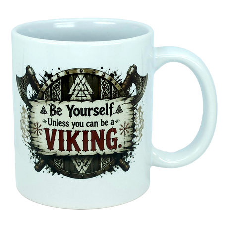 Start your day like a true legend with the Mug: Be Yourself Unless You Can Be A Viking Ceramic Mug (11 oz Capacity) from Nordic Wholesale. This white ceramic mug features striking Viking-themed artwork depicting two axes and a wooden shield, along with the empowering text: "Be Yourself. Unless you can be a VIKING." Ideal for fans of Norse mythology mugs and anyone who admires legendary warriors as part of their morning coffee ritual.