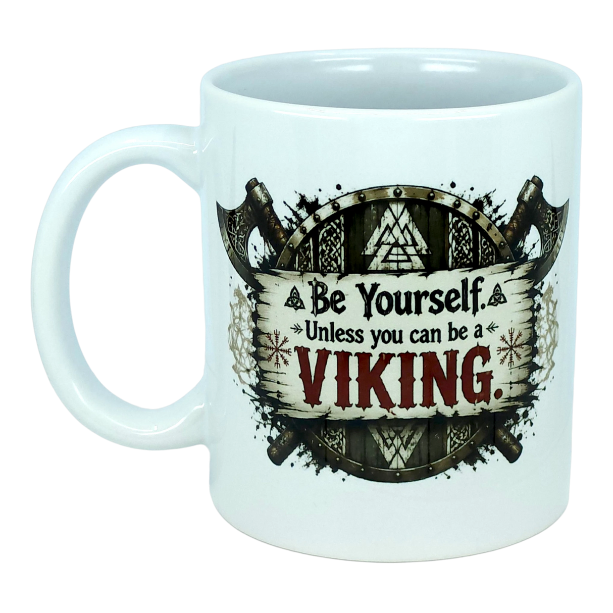 Introducing the Mug: Be Yourself Unless You Can Be A Viking Ceramic Mug (11 oz Capacity) from Nordic Wholesale. This ceramic coffee mug features a bold Viking-themed design with crossed axes and runes. The text reads: "Be Yourself. Unless you can be a Viking," with "Viking" highlighted in large, bold letters. Perfect for Norse mythology enthusiasts or anyone looking for a striking Nordic warrior gift, this mug celebrates your love of all things Viking in style.