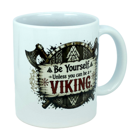 Introducing the Mug: Be Yourself Unless You Can Be A Viking Ceramic Mug (11 oz Capacity) from Nordic Wholesale. This white ceramic mug features a striking Viking axe and shield graphic, with the phrase "Be Yourself. Unless you can be a VIKING" printed on it—the word "VIKING" boldly highlighted in large red letters. It's the perfect gift for Norse mythology enthusiasts or anyone who appreciates bold Nordic warrior-inspired designs.